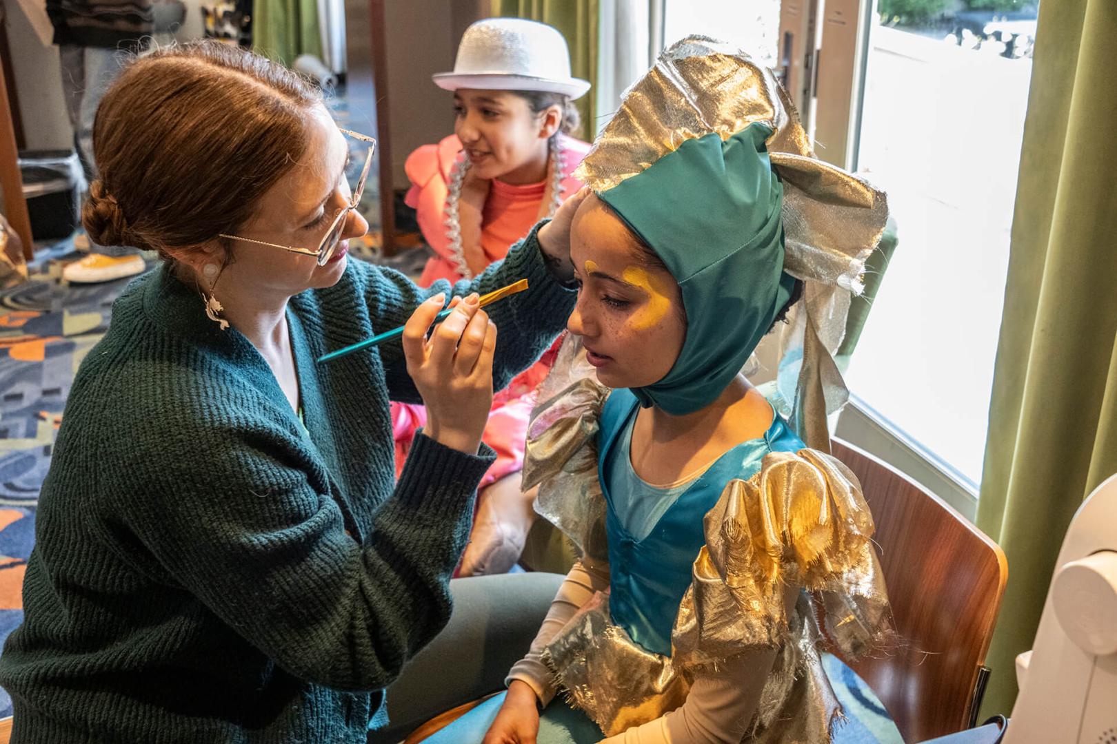 Children getting stage makeup