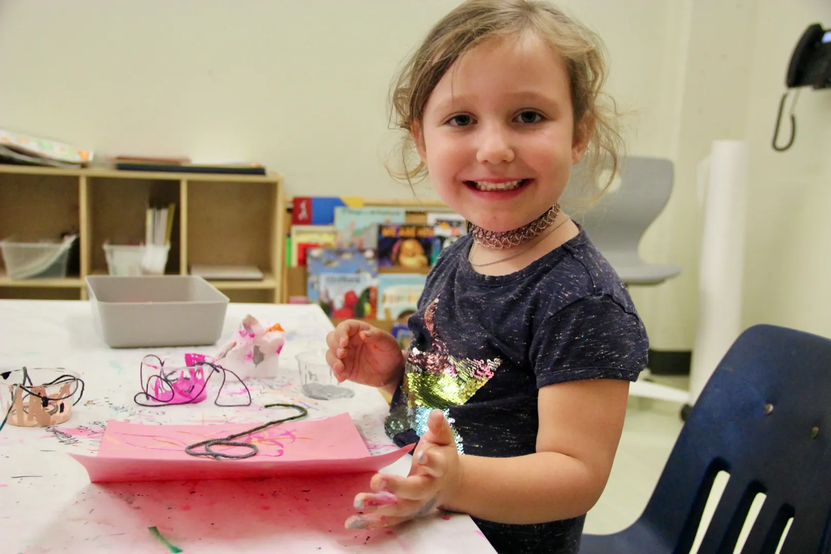Smiling girl making art