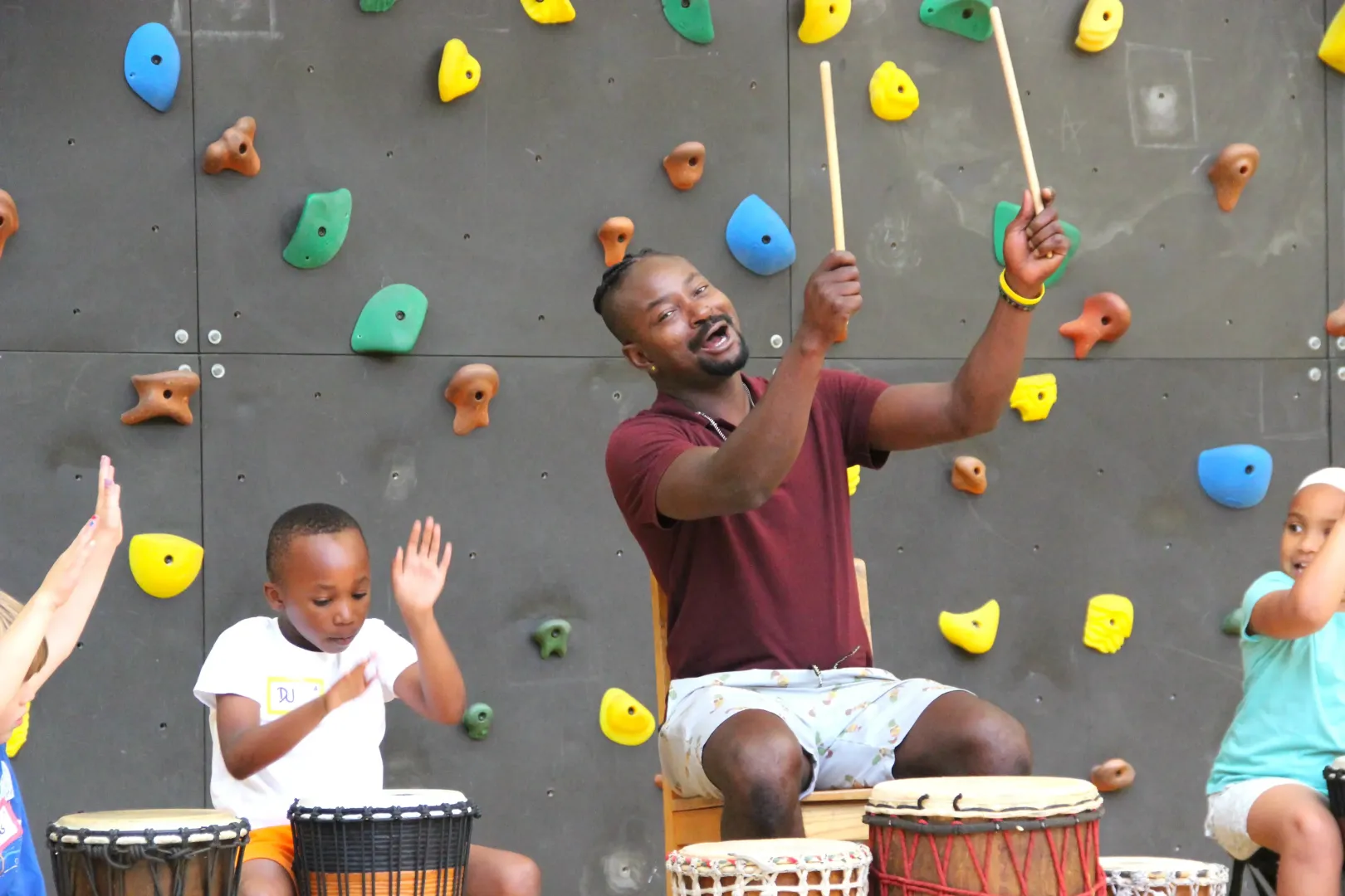 Teacher and child playing drums