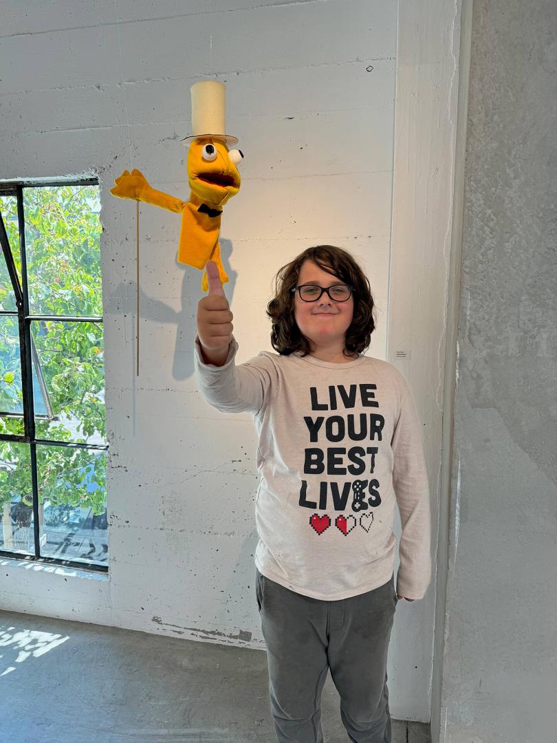 Child holding up a puppet